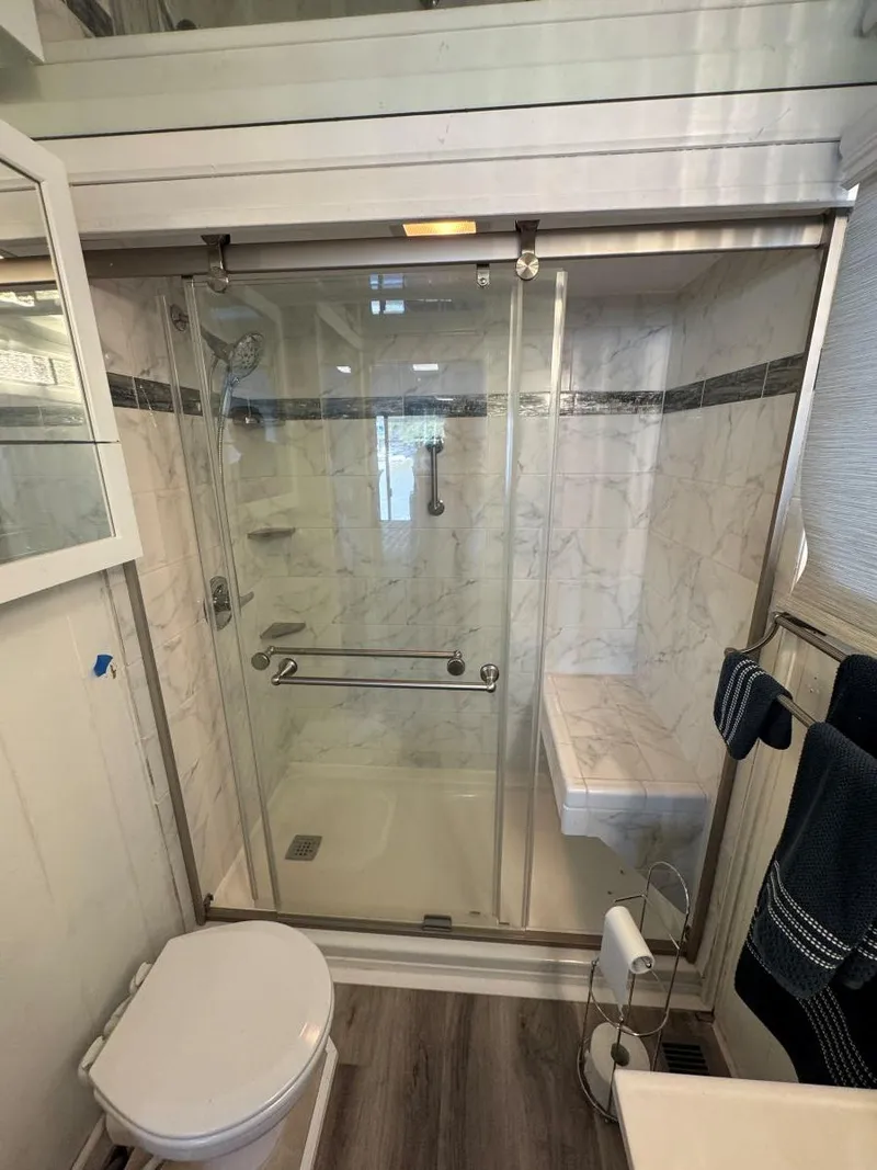 Slide: The Image of Bathroom in 1986 Stardust Cruisers 18 X 80 Houseboat with glass shower and modern fixtures. - 43