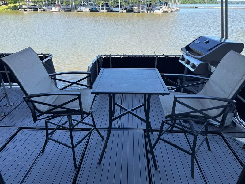 Slide: The Image of Outdoor seating on 1986 Stardust Cruisers 18 X 80 houseboat deck with lake view. - 46