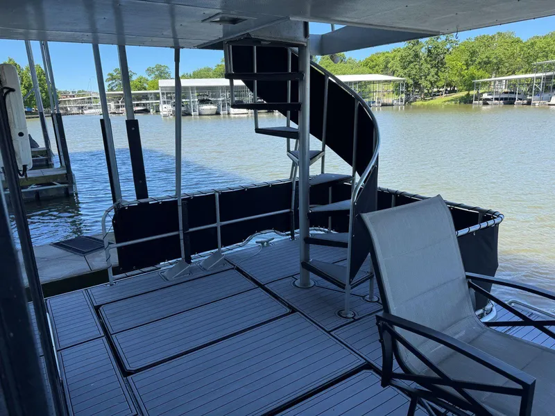 Slide: The Image of 1986 Stardust Cruisers 18 X 80 Houseboat with spiral staircase and lake view. - 47