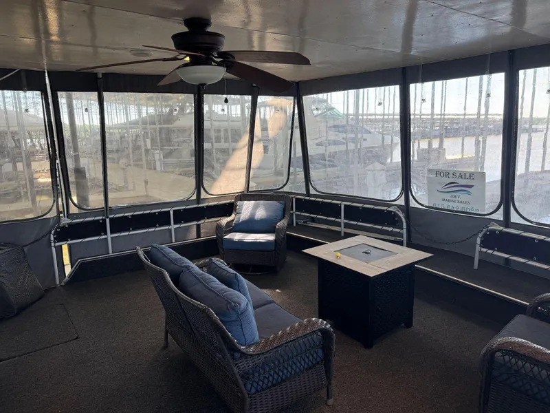 Slide: The Image of Enclosed deck of 1986 Stardust Cruisers 18 X 80 houseboat with seating and ceiling fan. - 5