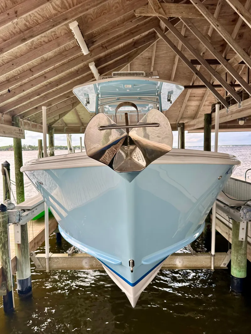 Slide: The Image of 2021 Albury Brothers 27 boat docked under a wooden shelter. - 3