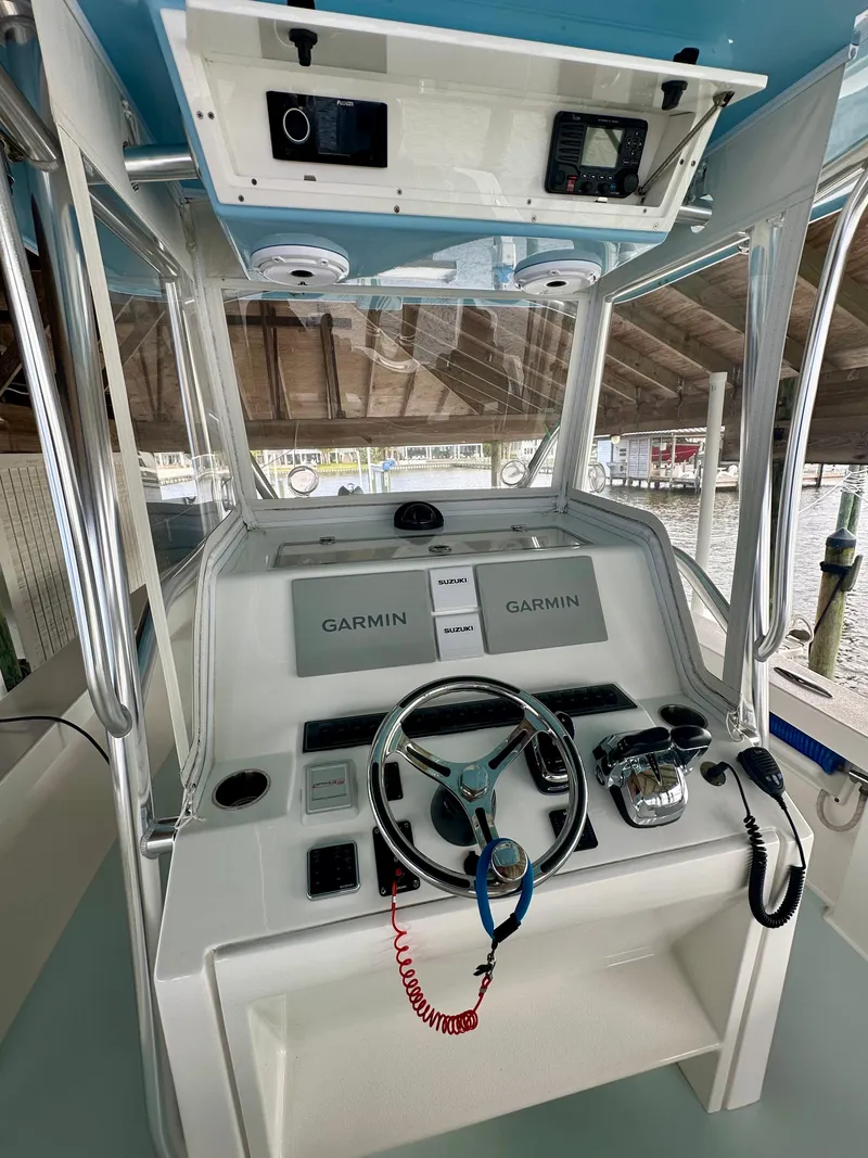 Slide: The Image of 2021 Albury Brothers 27 boat helm with Garmin navigation system and steering wheel. - 8