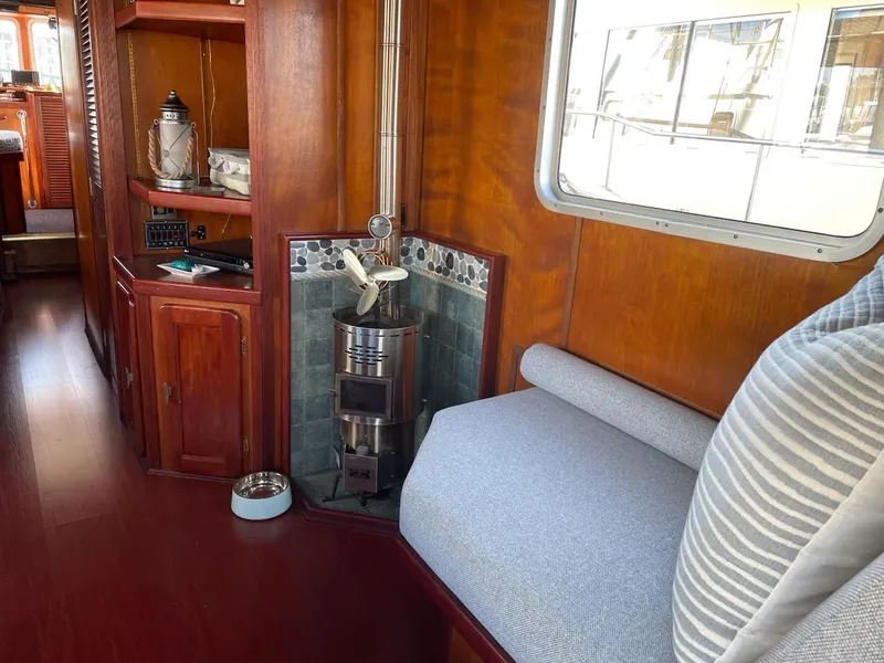 Slide: The Image of Cozy interior of a 2010 custom trawler with wood paneling and a small stove. - 10