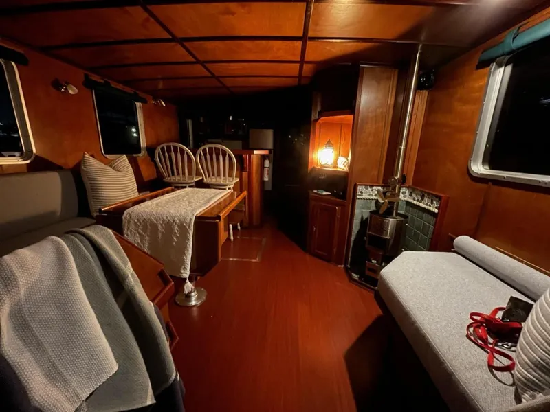 Slide: The Image of Cozy interior of a 2010 custom trawler with wooden furnishings and ambient lighting. - 14