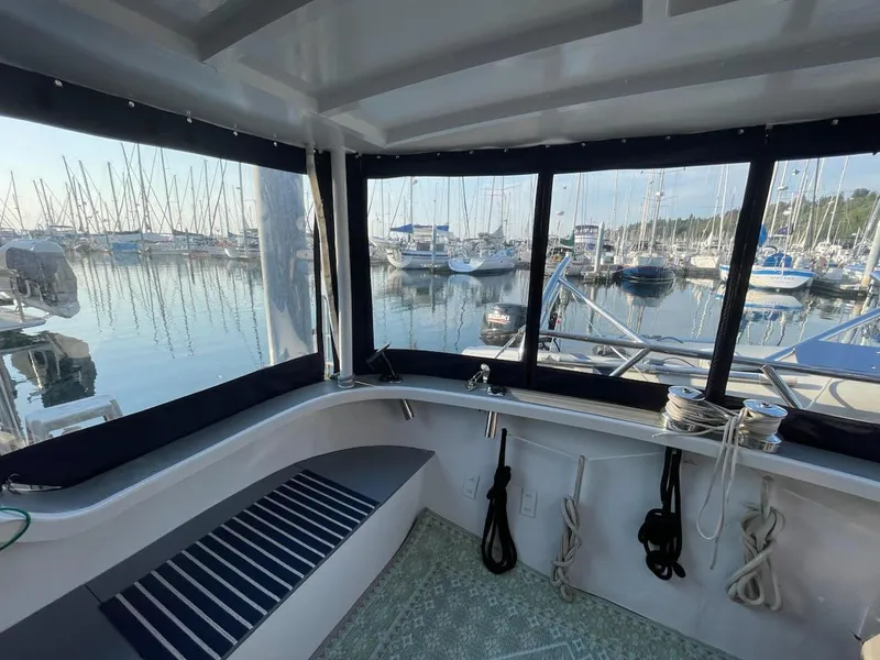 Slide: The Image of Interior view of a 2010 custom trawler with marina in the background. - 17