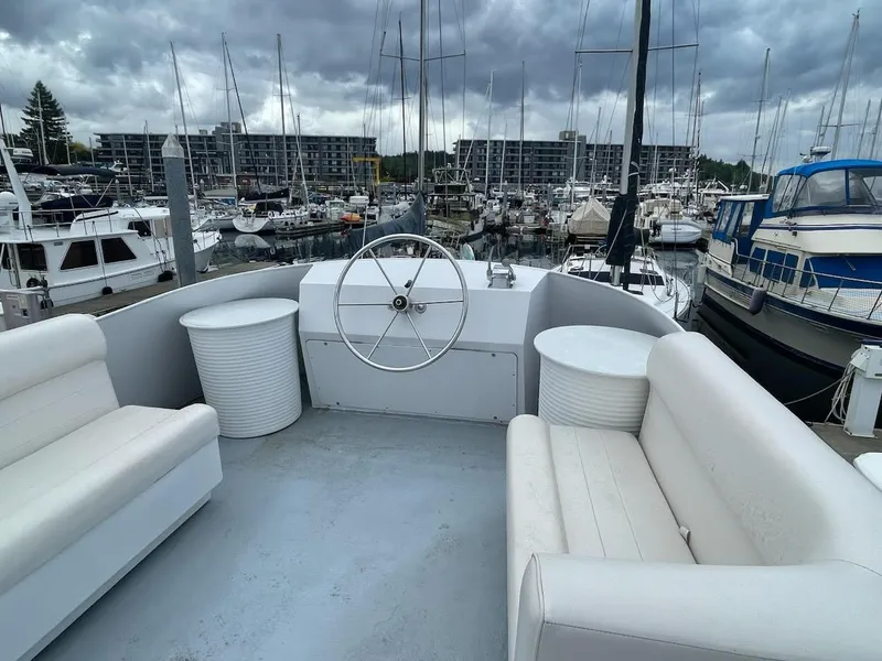 Slide: The Image of Custom 2010 trawler with white seating, docked in a marina under cloudy skies. - 19