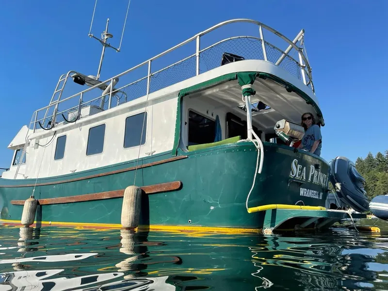 Slide: The Image of Custom 2010 Trawler "Sea Prince" on water, green and white exterior, sunny day. - 2