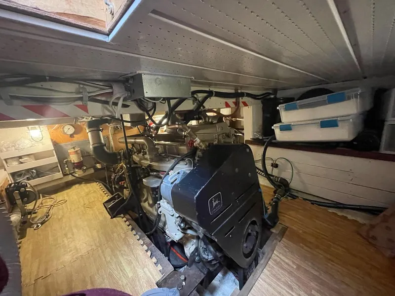 Slide: The Image of Engine room of a 2010 custom trawler, showcasing machinery and storage boxes. - 22