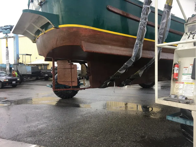 Slide: The Image of Custom 2010 trawler being lifted for maintenance in a shipyard. - 3
