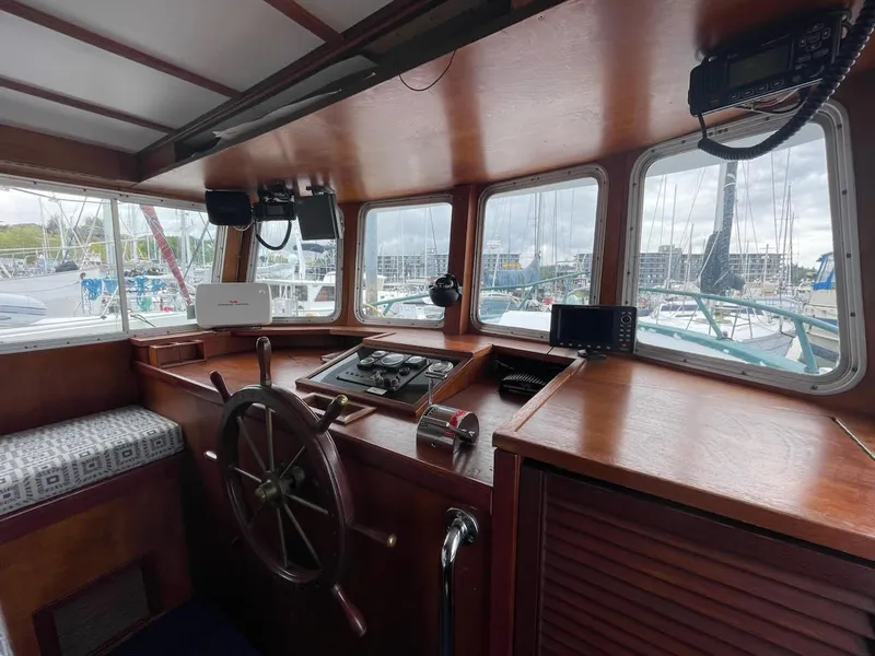 Slide: The Image of Interior of a 2010 custom trawler with wooden helm and navigation equipment. - 4