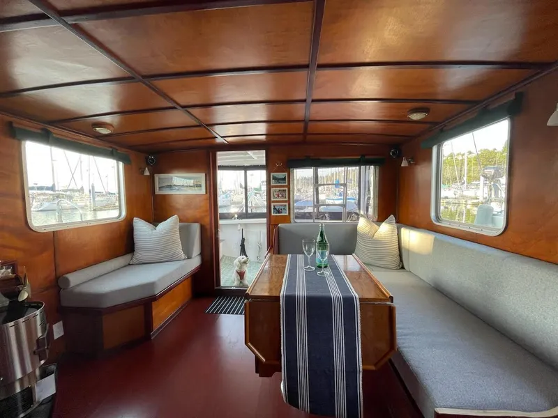 Slide: The Image of Cozy interior of a 2010 custom trawler with wooden paneling and comfortable seating. - 7