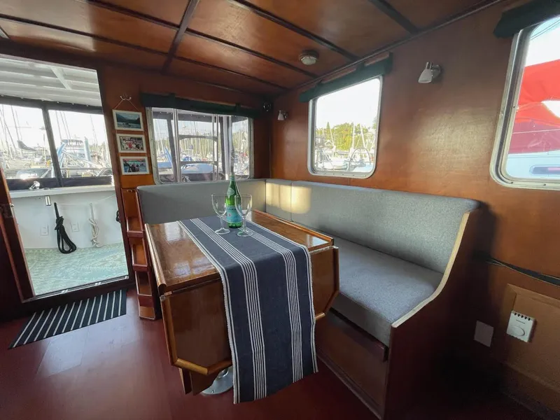 Slide: The Image of Interior of a 2010 custom trawler with wooden finishes and cozy seating area. - 8