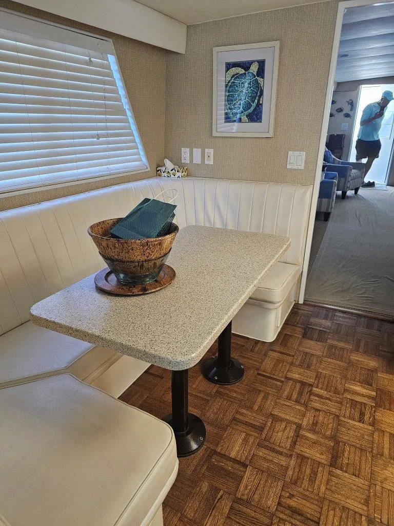 Slide: The Image of 1987 Hatteras 70 Cockpit Motor Yacht interior with dining area and decorative bowl. - 12
