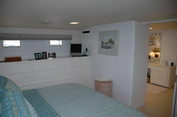Slide: The Image of Bedroom interior of 1987 Hatteras 70 Cockpit Motor Yacht with dresser and decor. - 13