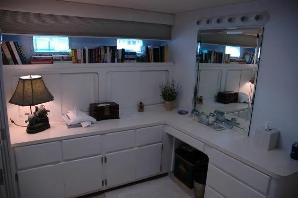 Slide: The Image of Interior of 1987 Hatteras 70 Cockpit Motor Yacht with vanity, books, and lamp. - 14