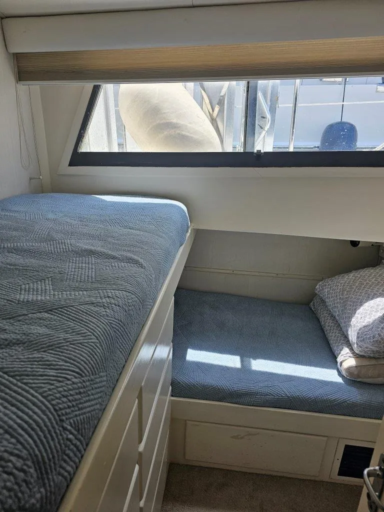 Slide: The Image of Interior cabin of 1987 Hatteras 70 Cockpit Motor Yacht with twin beds and window. - 19