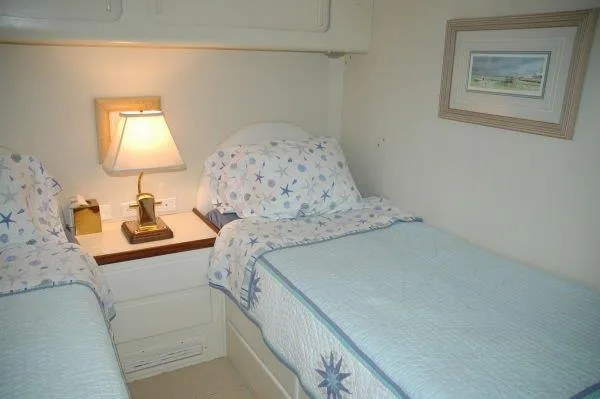 Slide: The Image of Twin beds in a cozy cabin of a 1987 Hatteras 70 Cockpit Motor Yacht. - 23