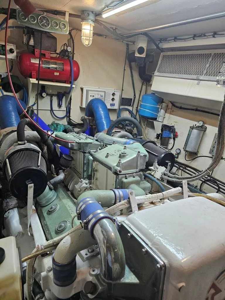 Slide: The Image of Engine room of 1987 Hatteras 70 Cockpit Motor Yacht with visible machinery and equipment. - 25