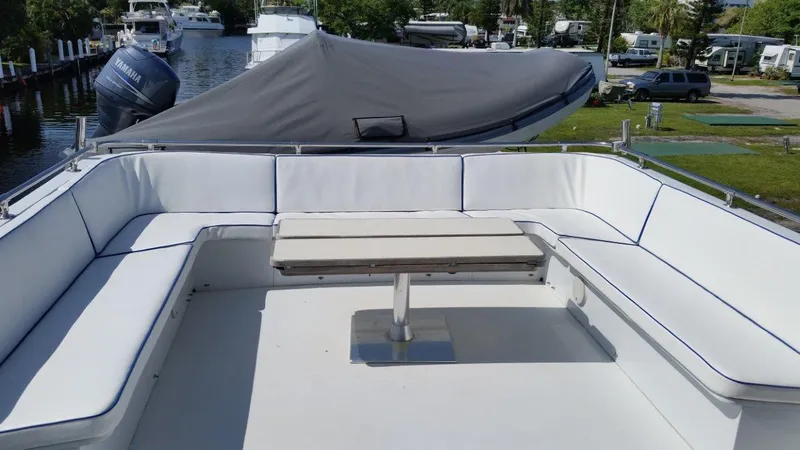 Slide: The Image of 1987 Hatteras 70 Cockpit Motor Yacht with spacious outdoor seating and table. - 3