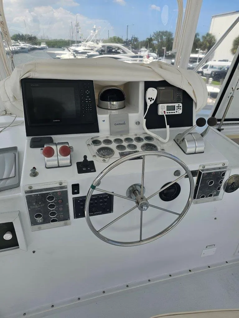 Slide: The Image of Helm of 1987 Hatteras 70 Cockpit Motor Yacht with navigation equipment and steering wheel. - 6