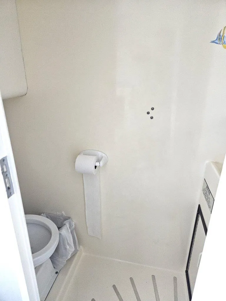 Slide: The Image of Bathroom interior of 1987 Hatteras 70 Cockpit Motor Yacht, featuring toilet and toilet paper holder. - 7