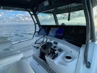 Slide: The Image of 2019 HCB 53 Sueños boat cockpit with ocean view, featuring modern controls and seating. - 11