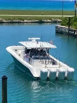 Slide: The Image of 2019 HCB 53 Sueños boat with multiple outboard engines on a clear blue waterway. - 2