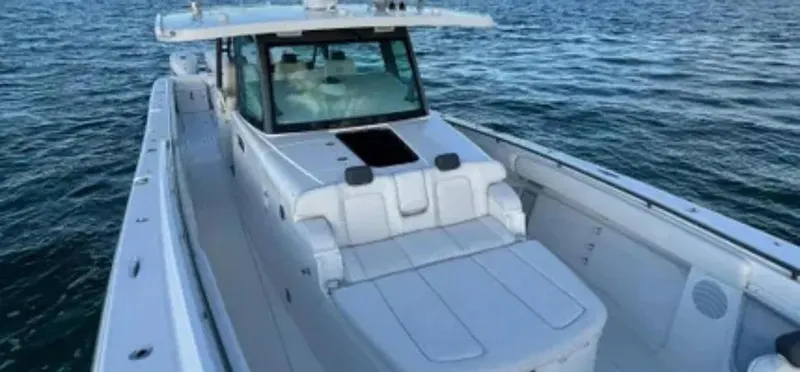 Slide: The Image of 2019 HCB 53 Sueños boat on water, showcasing sleek design and spacious deck. - 3