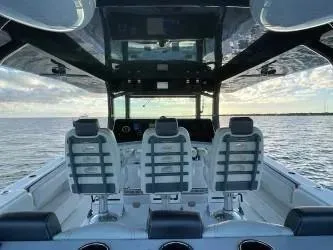 Slide: The Image of 2019 HCB 53 Sueños boat interior with three seats, ocean view, and modern design. - 9