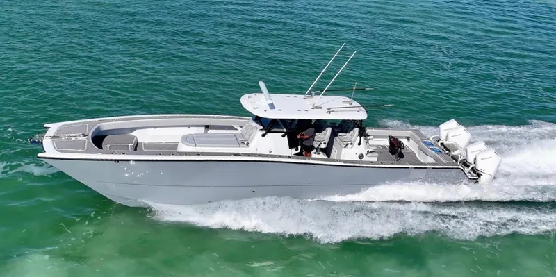 The Image of 2021 Freeman 47 boat cruising on clear blue water, side view. - 0