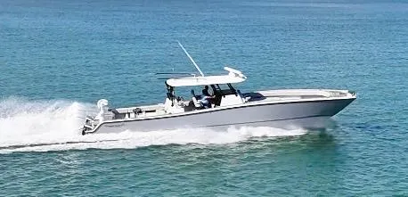 Slide: The Image of 2021 Freeman 47 boat cruising swiftly on clear blue water. - 1