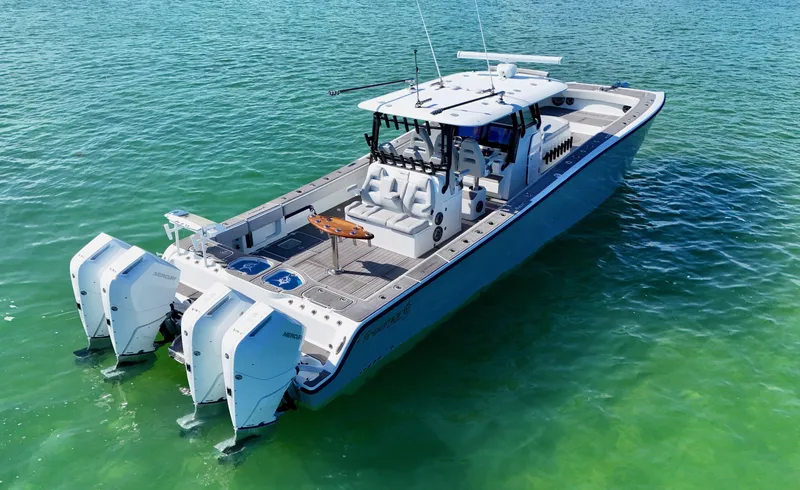 Slide: The Image of 2021 Freeman 47 boat on clear turquoise water, featuring dual outboard engines. - 14