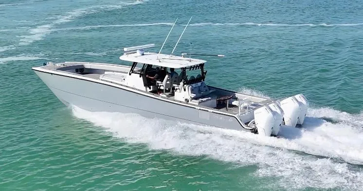 Slide: The Image of Freeman 47 boat cruising on clear blue water, 2021 model. - 2