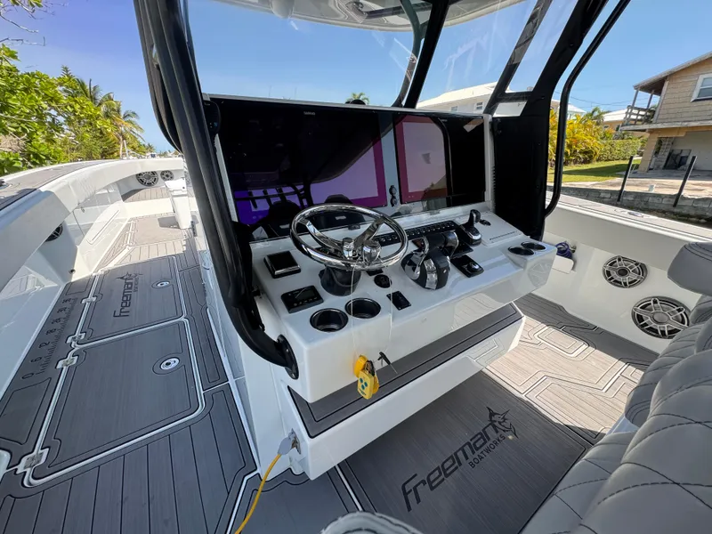 Slide: The Image of Interior of a 2021 Freeman 47 boat with modern steering console and seating. - 21