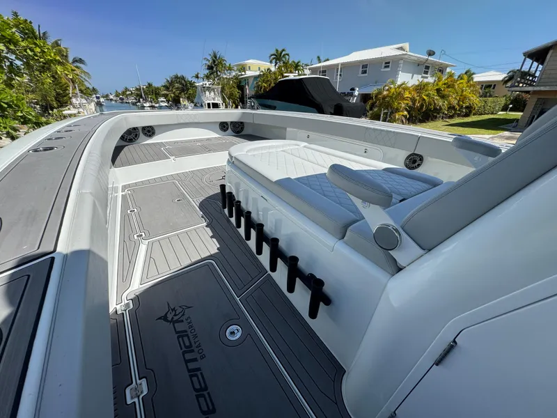 Slide: The Image of 2021 Freeman 47 boat with sleek seating and spacious deck in a sunny marina. - 24