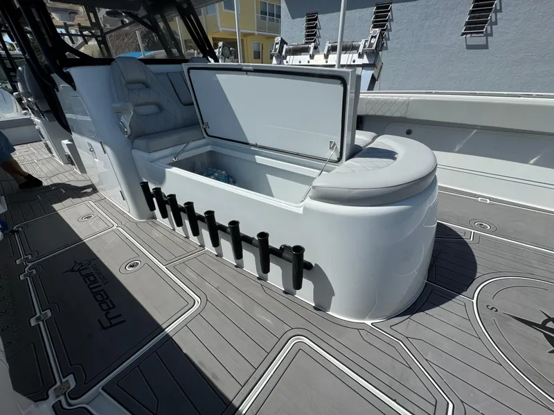 Slide: The Image of Freeman 47 boat interior with open storage compartment, rod holders, and cushioned seating, 2021 model. - 29