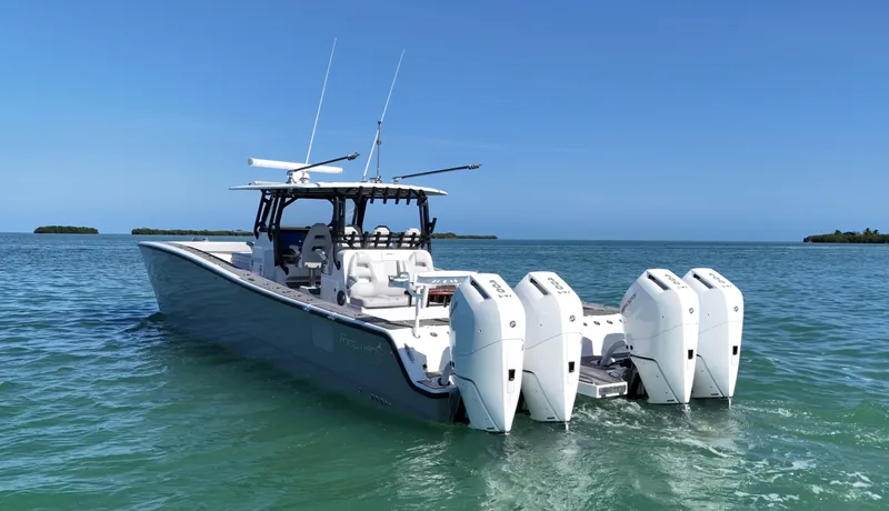 Slide: The Image of 2021 Freeman 47 boat with four engines on calm blue water. - 3