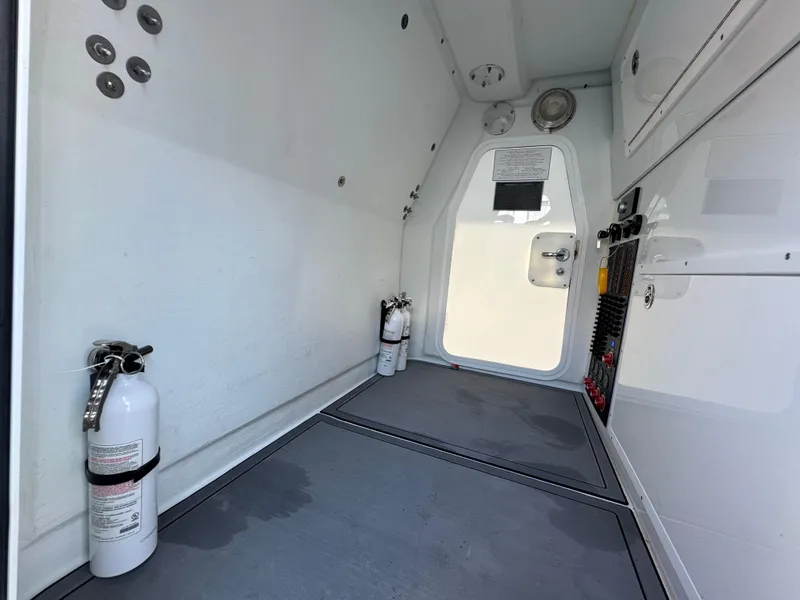 Slide: The Image of Interior of a 2021 Freeman 47 boat with fire extinguishers and storage compartments. - 31