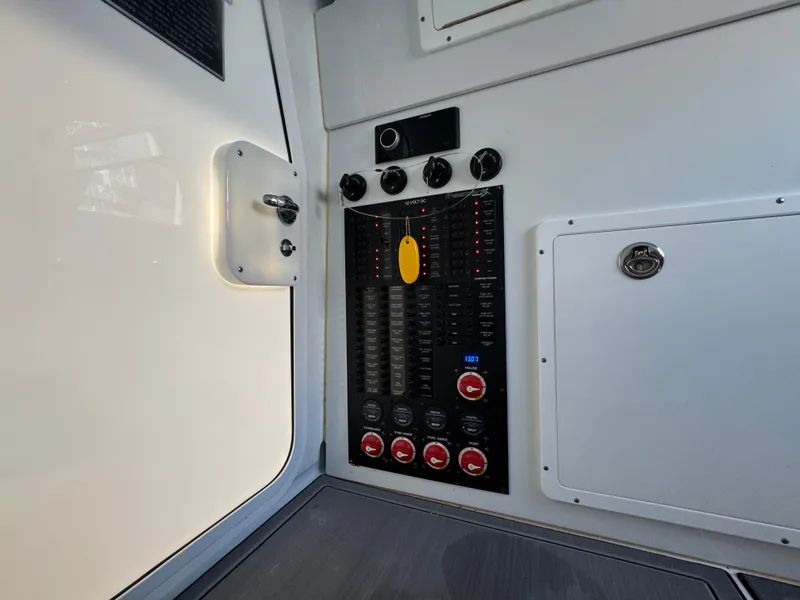 Slide: The Image of Control panel inside a 2021 Freeman 47 boat, featuring switches and dials. - 32
