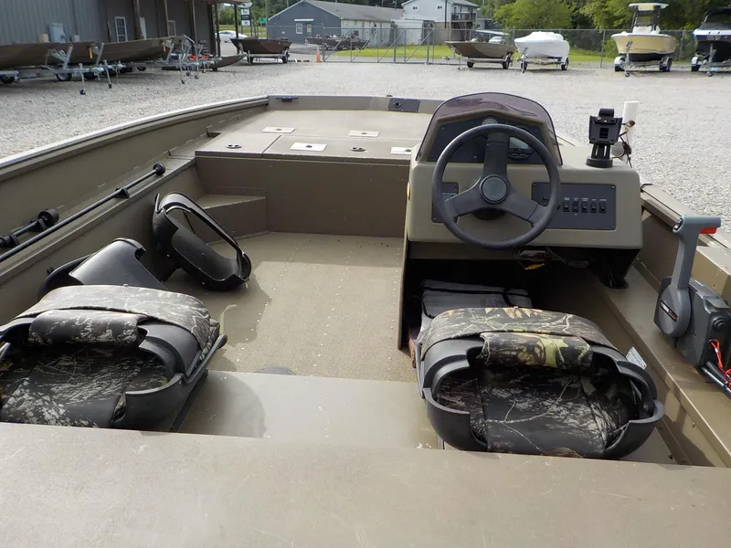 Slide: The Image of 2021 G3 20 SC boat interior with camouflage seats and steering console. - 16