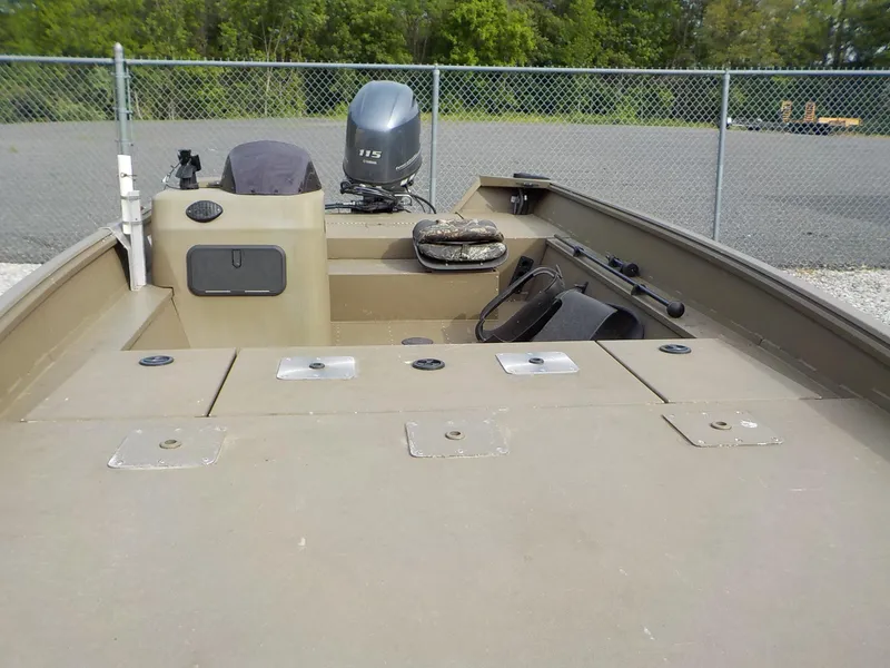 Slide: The Image of 2021 G3 20 SC boat with Yamaha 115 engine, parked near a chain-link fence. - 17