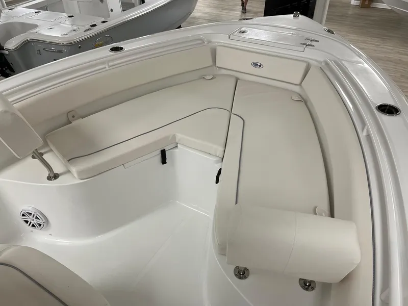 Slide: The Image of 2025 Sea Hunt Ultra 245 SE boat interior with white cushioned seating. - 14
