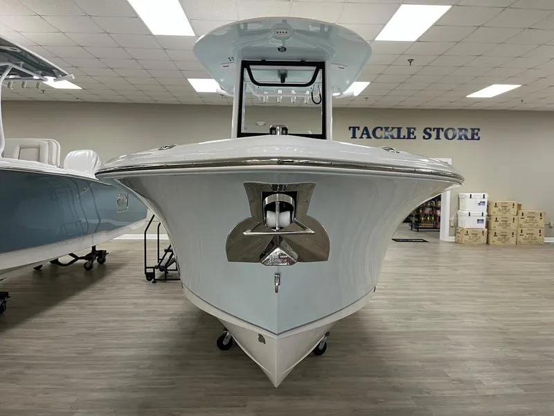 Slide: The Image of 2025 Sea Hunt Ultra 245 SE boat displayed in a tackle store showroom. - 4