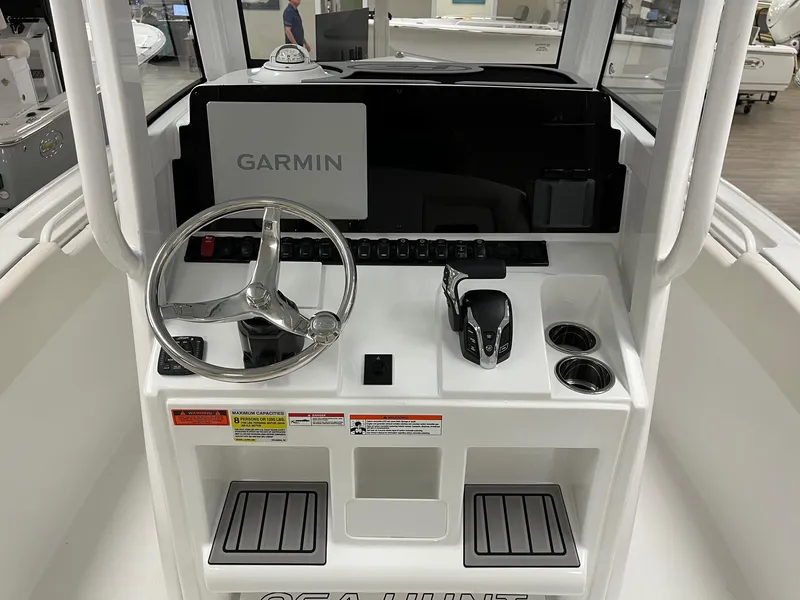 Slide: The Image of 2025 Sea Hunt Ultra 245 SE boat console with Garmin display and steering wheel. - 5