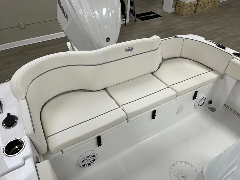 Slide: The Image of 2025 Sea Hunt Ultra 245 SE boat with white cushioned seating and Yamaha engine. - 8