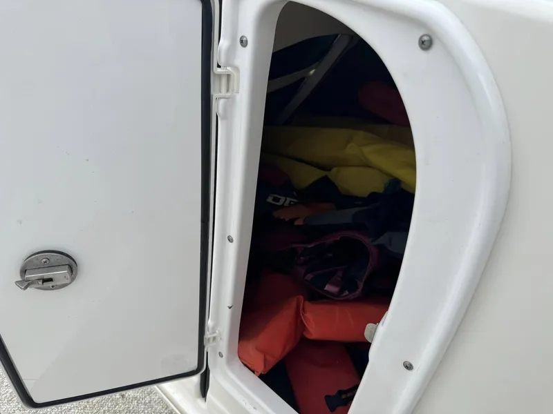 Slide: The Image of Open storage compartment on Azure AZ298 boat, revealing life jackets inside. - 10