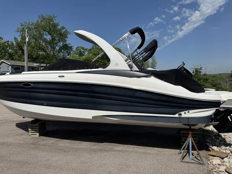 Slide: The Image of 2012 Azure AZ298 boat on stands, black and white design, parked outdoors. - 11