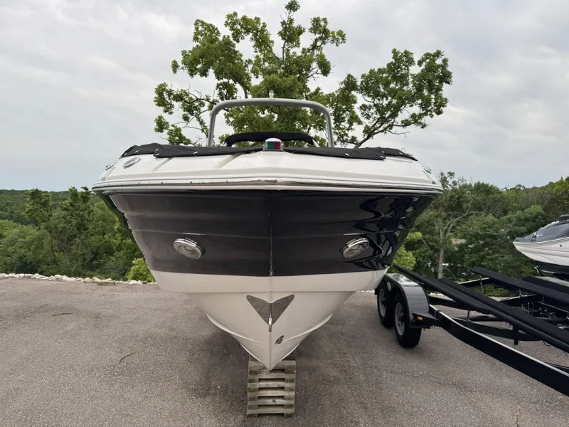 Slide: The Image of 2012 Azure AZ298 boat on trailer, parked outdoors with trees in the background. - 12