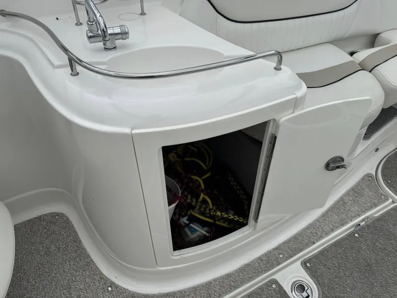 Slide: The Image of Open storage compartment on Azure AZ298 boat, featuring a sink and seating area, 2012 model. - 15