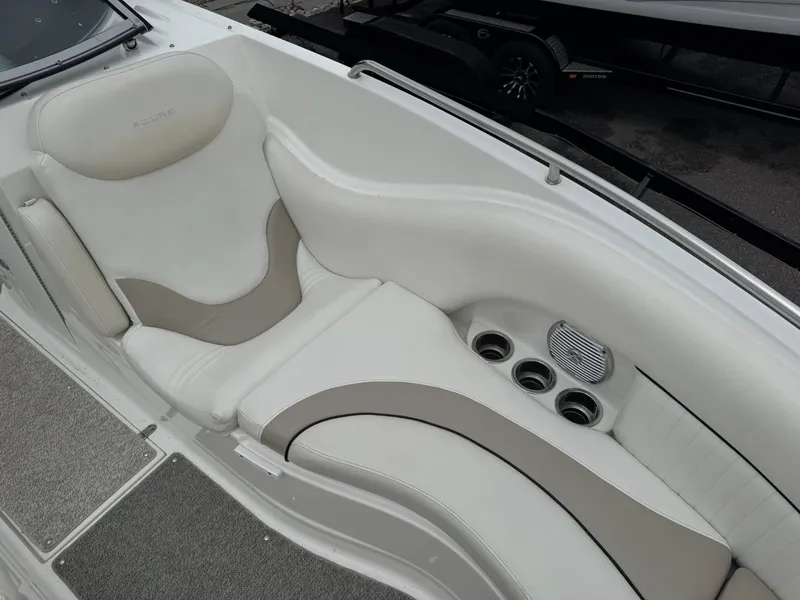 Slide: The Image of 2012 Azure AZ298 boat interior with white and beige seating, cup holders, and speaker. - 18